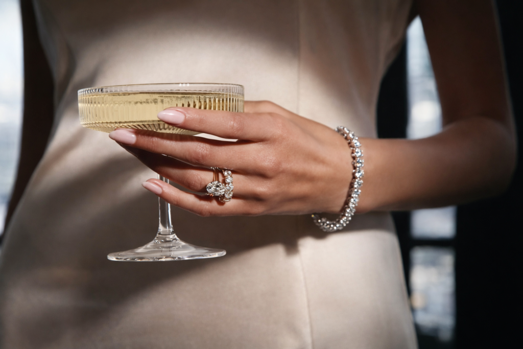 Elegant women holding champagne glass, wearing diamond jewelry