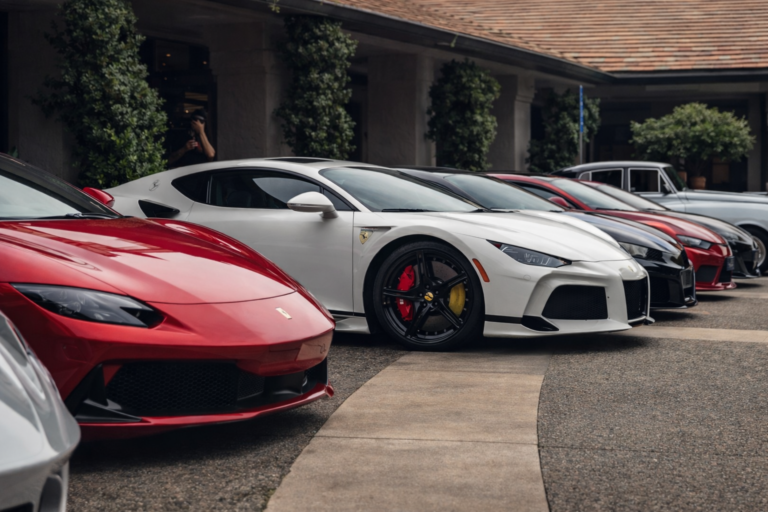 AI-generated image of Ferrari and other luxury supercars displayed in a row during Monterey Car Week, showcasing high-end automotive design and performance.