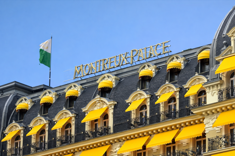 AI-generated image of the Montreux Palace hotel rooftop facade with yellow awnings, Belle Époque architecture and the Montreux Palace sign.