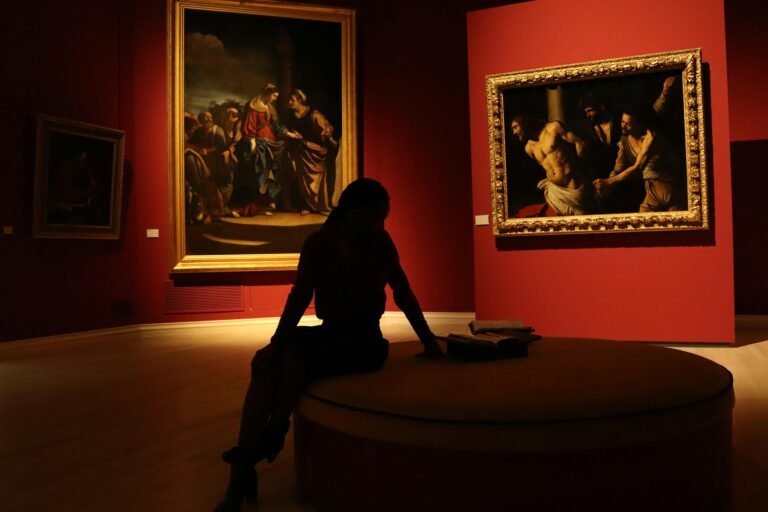 Art collector observing classic paintings inside an elegant museum gallery