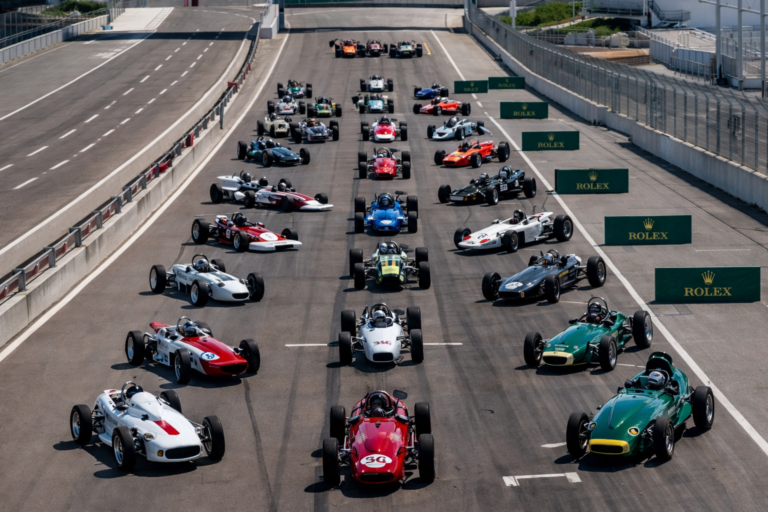 AI-generated scene of classic open-wheel Formula race cars arranged across a starting grid at a professional circuit before the start of a historic motorsport race.
