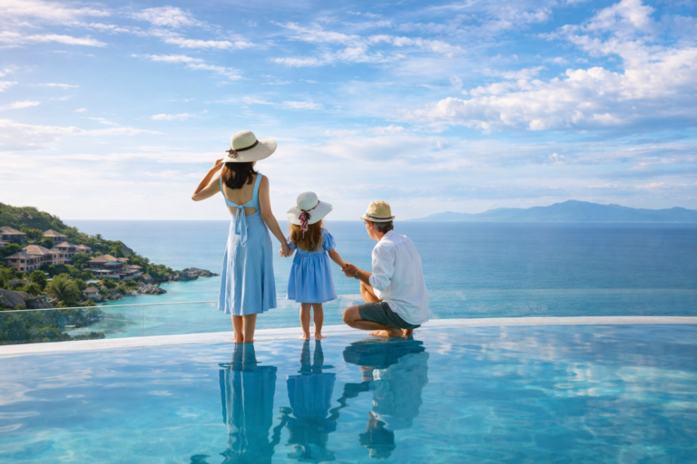 Family enjoying a luxury infinity pool overlooking the ocean view
